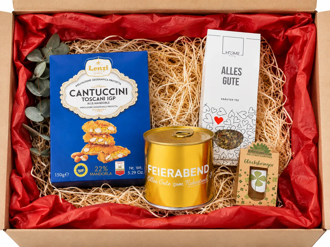 Geschenkbox zum Ruhestand mit Kuchen, Keksen, Tee und Glücksbringer für die Zukunft